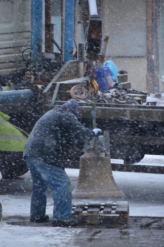 Bell being unloaded in snow storm